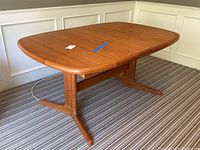 Front view showing rectangular teak top and twin pedestal base