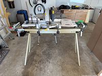 Front view of Mastercraft mitre saw mounted on stand in garage