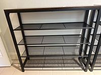 Front view showing entire rack with four mesh shelves and frame