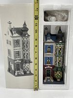 Full view of boxed porcelain model alongside measuring tape showing approximately 13.5 inches tall.