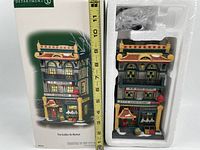 Front of box and collectible building measuring approximately 9 inches in height, showing exterior design and packaging.