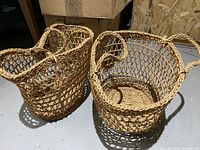 Two vintage open lattice rope baskets with woven oval bases, showing overall condition and rope handles.