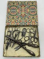 Decorative box open showing all vintage scissors inside with some overlapping