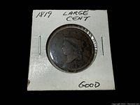 Front view of the 1819 Large Cent coin in white cardboard holder labeled with year, coin type, and condition.