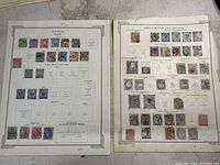 Photo showing two album pages, one with Germany Empire stamps and one with Great Britain and Ireland stamps, with multiple colored stamps arranged neatly.