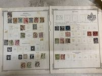 Two pages with antique stamps from Austria and Bavaria showing various colors and designs with some signs of wear on pages.