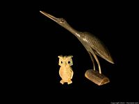 Both carved items displayed against black background, showing full front and side views