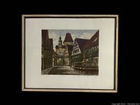 Framed colored etching depicting Rothenburg Markusturm street scene with signature and numbering below the image.
