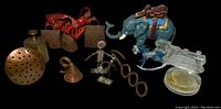 Lot overview on black background showing all metal and glass items together, illustrating condition and variety.