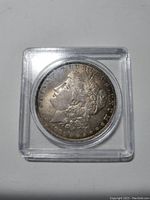 Obverse side of the 1883 O Morgan Silver Dollar showing Lady Liberty profile in protective case.