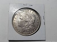 Obverse of 1889 Morgan Silver Dollar showing Lady Liberty bust, stars, and date.