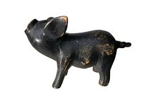Side view of black carved wooden pig showing shape and wear marks.
