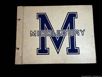 Cover of the photo album showing white cover with large blue M and Middlebury text