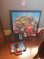 Full lot showing Avengers print, storage case with Iron Man figures, and additional Iron Man figure to right