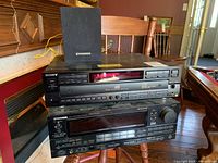 Front view showing Sony CD player, Pioneer receiver, and Pioneer speaker stacked on chair