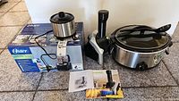 Oster food processor box, Yonanas ice cream maker unit, Hamilton Beach and Little Dipper crock pots with lids