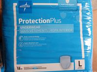 Close up of a single pack of Medline Protection Plus adult diapers in size Large with details on the packaging showing 18 diapers per pack, body contoured design, and super absorbent core.