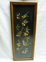 Full view of the framed cross stitch displaying birds on a fruit tree branch.