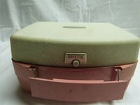 Closed view of the pink and cream Rayette hairsetter unit showing the button labeled 'Rayette' on exterior.