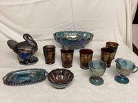 Overall front view of 11 piece lot of vintage carnival glass items including chicken covered dish, tumblers, bowls, tray, creamer and sugar set