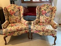 Front view of both chairs side by side showing upholstery pattern and wooden legs