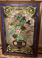 Full view of framed stained glass panel showing floral arrangement and decorative border
