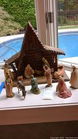Stable with all figurines arranged around in front of window overlooking pool