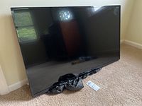 Front view of the Insignia flat screen TV showing the screen size and overall condition