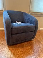Front three-quarter view of chair showing overall shape and upholstery condition