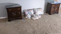 Two Ethan Allen nightstands on carpet with bedding between, showing overall condition and size