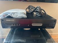 Panamax MAX 5100-EX power conditioner unit showing front panel with LED indicators and power outlets.