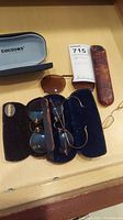 Overview of all four spectacles and their cases on table