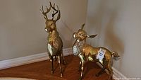Overall view of both brass deer sculptures