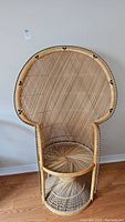 Front view of full wicker peacock chair showing overall shape and condition