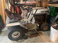 Left-front side view showing body, seat, steering wheel, front and rear wheels.