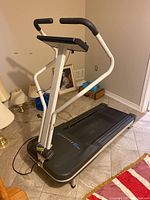 Weslo Cadence XT treadmill with black running belt and white frame, showing front and side views in indoor tiled room.