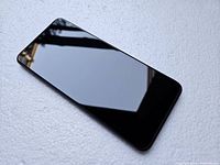 Front view of the phone screen reflecting surroundings, showing no visible damage.