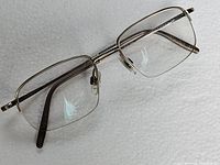 Front angle showing the rectangular shape and minimalist titanium frame.