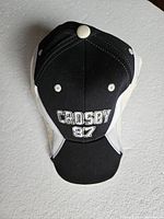 Front view of black and white baseball cap with 'CROSBY 87' embroidered on front panel.