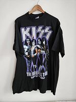 Full view front of black vintage KISS t-shirt showing band members and tour dates.
