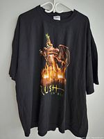 Front view of black vintage XXL Rush band t-shirt with dragon graphic and 'Rush In Rio' text.
