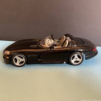 Side profile of the black Bourago Dodge Viper TR10 diecast model showing convertible seating and smooth glossy paint finish.