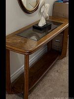 Photo of wood hall console table approx 5 ft long with glass insert top and wooden bottom shelf