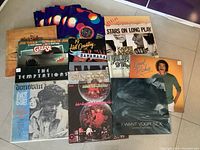 Photo showing first group of record albums including George Michael, The Temptations, Donovan, and others.