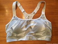 Front view of the Under Armour grey toned sports bra showing the pattern and logo on the band.