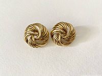 Front view of the pair of gold tone twisted rope design earrings showing circular shape and texture.
