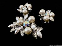 Close-up photo showing the brooch and earrings highlighting pearls, marquise-cut rhinestones, and round rhinestones with iridescent center on brooch.