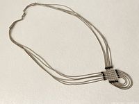 Full view of vintage sterling silver necklace with multi-strand design and clasp visible.