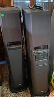 Pair of Sony home theater tower speakers standing side-by-side indoors, showing full height and general condition.