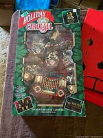 Photo of the vintage Mr. Christmas Holiday Carousel in original box showing six carousel horses and organ base visible through window.